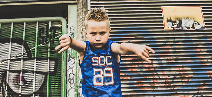 A young boy hiphopping in urban environment.